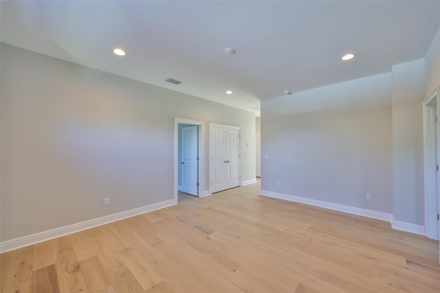 empty room with baseboards, light wood-style floors, and recessed lighting