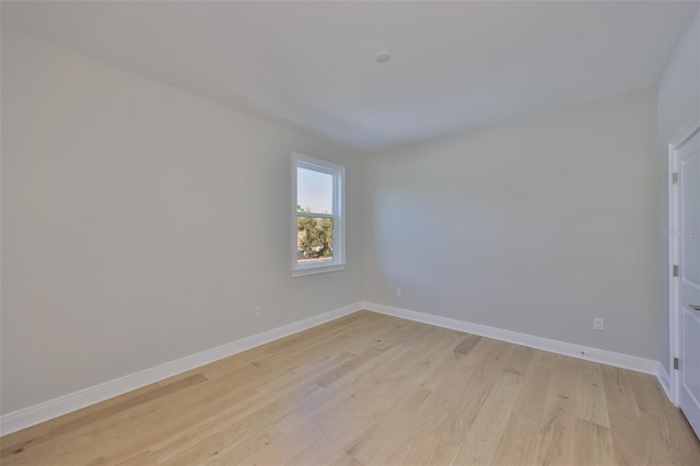 unfurnished room featuring light wood-type flooring and baseboards