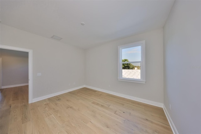 unfurnished room with light wood finished floors and baseboards