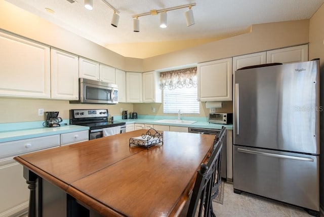 kitchen featuring white cabinetry, a toaster, appliances with stainless steel finishes, and a sink