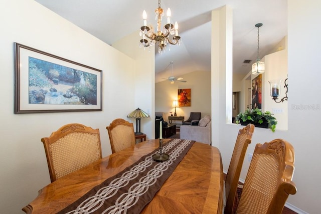 dining space featuring visible vents, an inviting chandelier, and vaulted ceiling