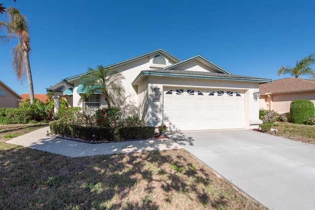 ranch-style house with concrete driveway, a garage, and stucco siding