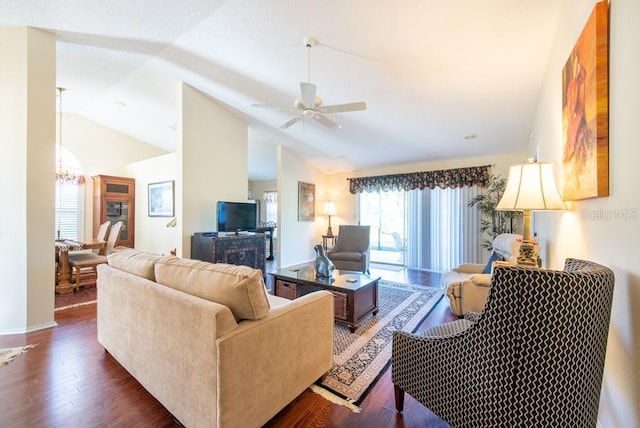 living room with high vaulted ceiling, dark wood-style floors, and ceiling fan with notable chandelier