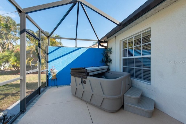 view of patio featuring a lanai