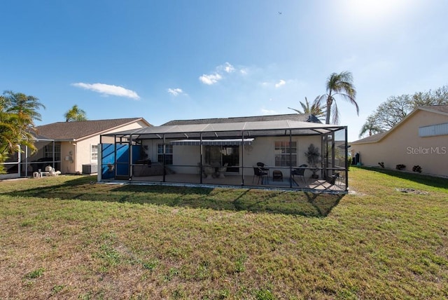 rear view of property with glass enclosure, a patio, a yard, stucco siding, and central air condition unit