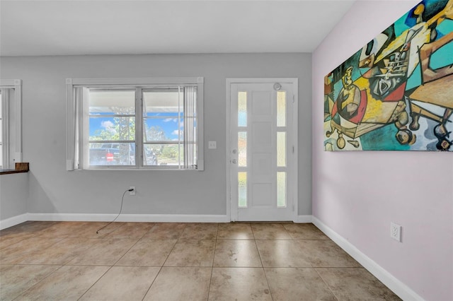 tiled entrance foyer with baseboards
