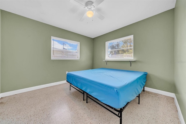 bedroom featuring baseboards and ceiling fan