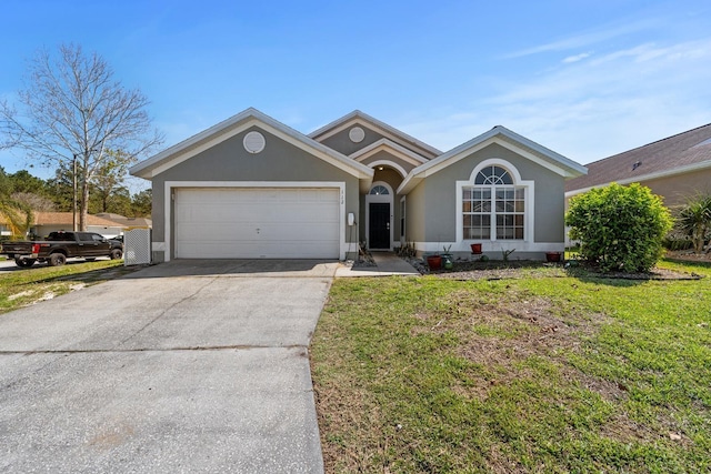 single story home featuring stucco siding, driveway, an attached garage, and a front lawn