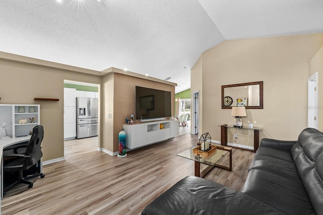 living room featuring visible vents, baseboards, lofted ceiling, light wood-style floors, and a textured ceiling