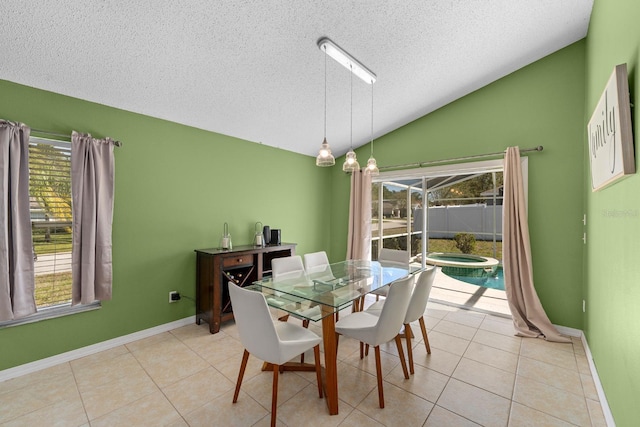 dining space featuring light tile patterned floors, baseboards, a textured ceiling, and lofted ceiling