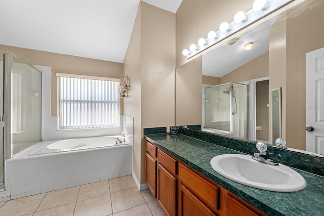 full bathroom with vanity, vaulted ceiling, a shower stall, tile patterned floors, and a bath