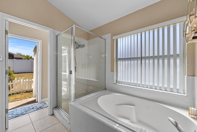 full bath with tile patterned floors, a stall shower, and a bath