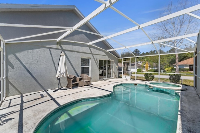 view of swimming pool featuring glass enclosure, a patio area, and a pool with connected hot tub