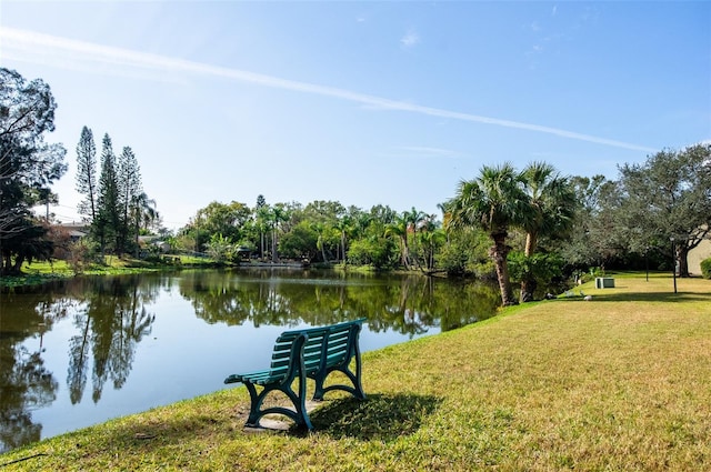 view of community with a lawn and a water view