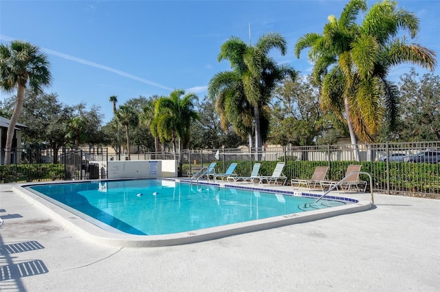 pool with a patio and fence