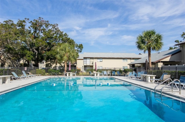 pool featuring a patio and fence