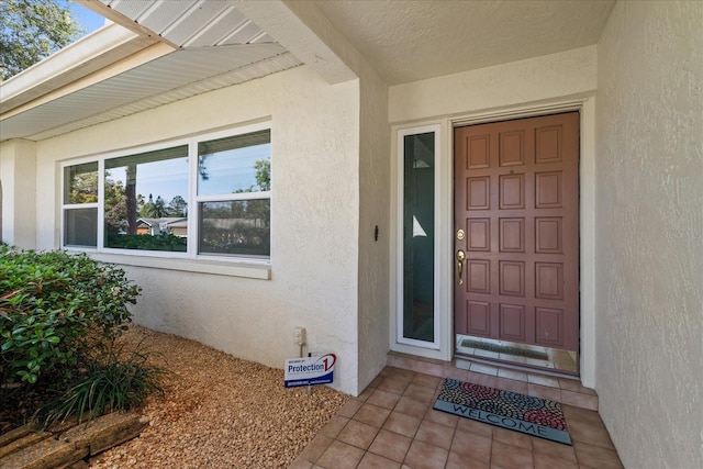 property entrance with stucco siding