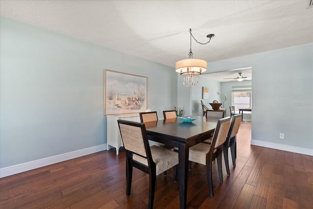 dining room featuring baseboards, dark wood-style flooring, and ceiling fan with notable chandelier