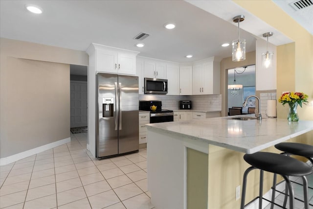 kitchen with a peninsula, visible vents, appliances with stainless steel finishes, and a sink