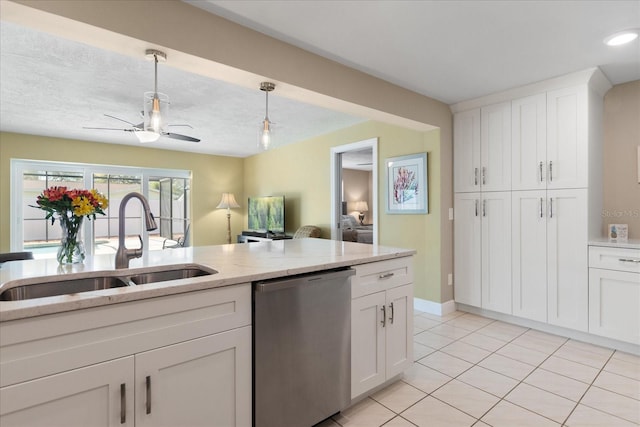 kitchen featuring white cabinetry, ceiling fan, hanging light fixtures, a sink, and dishwasher