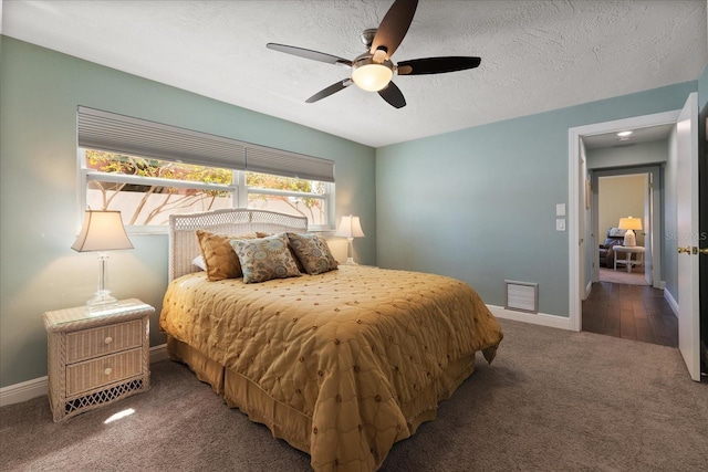 bedroom featuring baseboards, carpet, a ceiling fan, and a textured ceiling