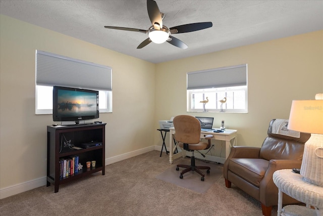 office area featuring baseboards, ceiling fan, and carpet flooring