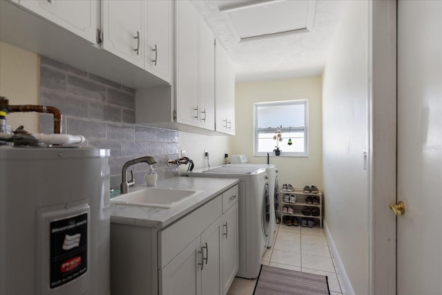 clothes washing area featuring electric water heater, baseboards, washer and clothes dryer, light tile patterned floors, and a sink