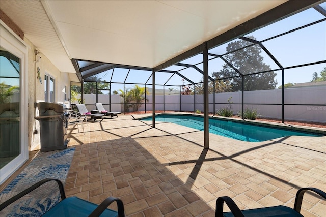 view of swimming pool featuring a patio, a fenced in pool, area for grilling, a fenced backyard, and a lanai