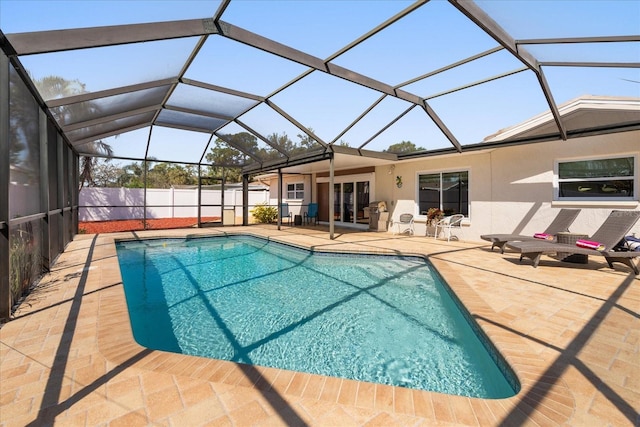 view of pool featuring a patio, fence, a fenced in pool, and a lanai