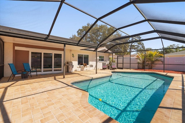 view of swimming pool with a lanai, a fenced in pool, fence private yard, and a patio