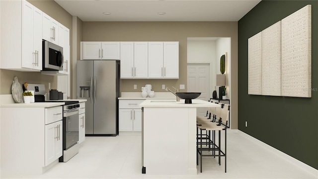 kitchen with a kitchen island, white cabinets, a kitchen breakfast bar, and stainless steel appliances