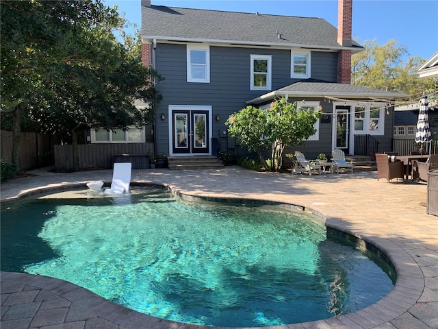 view of swimming pool featuring a fenced in pool, fence, entry steps, french doors, and a patio