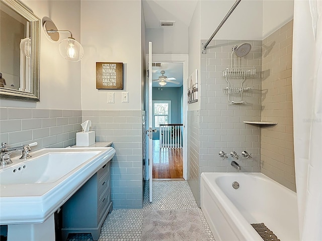 bathroom featuring tile patterned floors, visible vents, shower / bath combo, tile walls, and ceiling fan