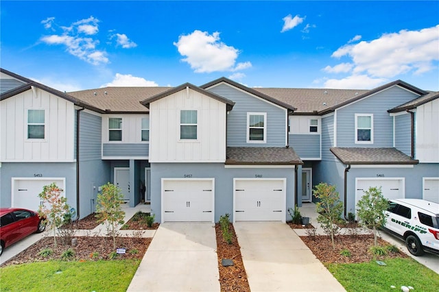 multi unit property featuring driveway, stucco siding, a shingled roof, a garage, and board and batten siding