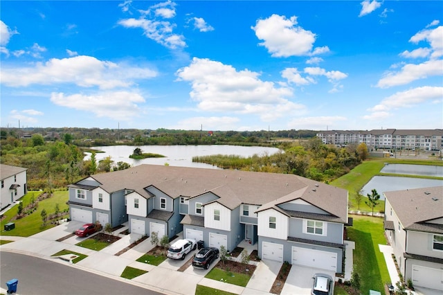 drone / aerial view featuring a residential view and a water view