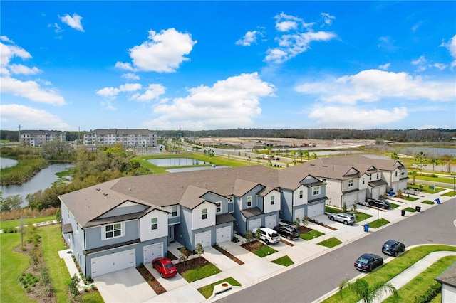 birds eye view of property featuring a residential view and a water view