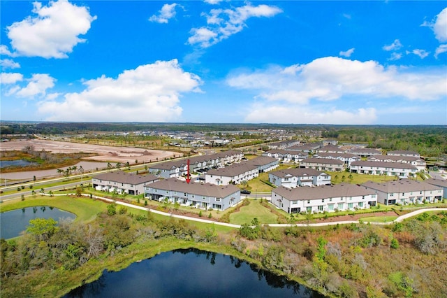 drone / aerial view featuring a residential view and a water view