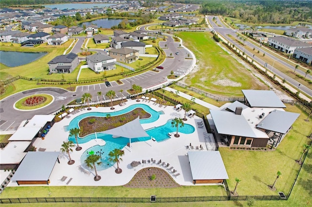 drone / aerial view featuring a water view and a residential view