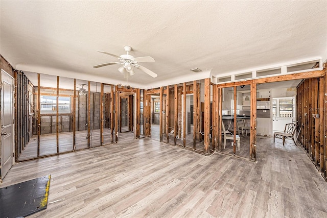 miscellaneous room featuring visible vents, wood finished floors, a textured ceiling, and ceiling fan