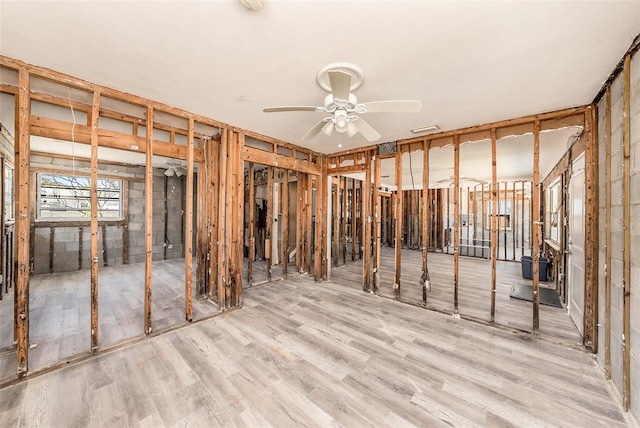 below grade area featuring wood finished floors, visible vents, and ceiling fan