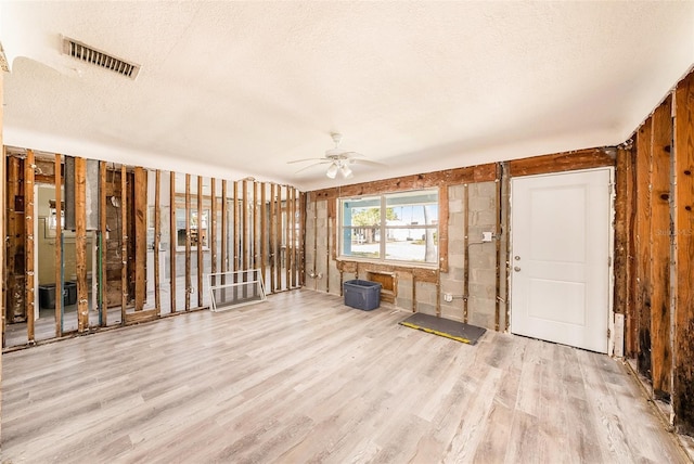 miscellaneous room featuring visible vents, a textured ceiling, a ceiling fan, and wood finished floors