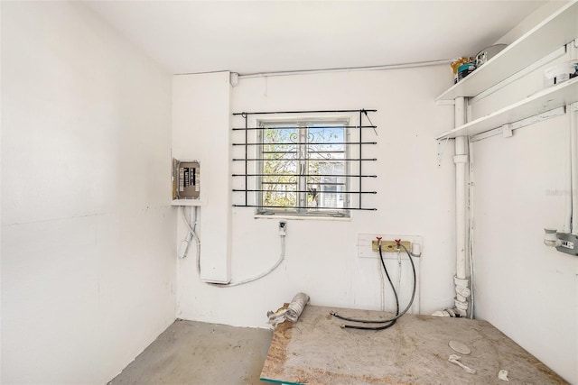 interior space with electric panel, washer hookup, and laundry area