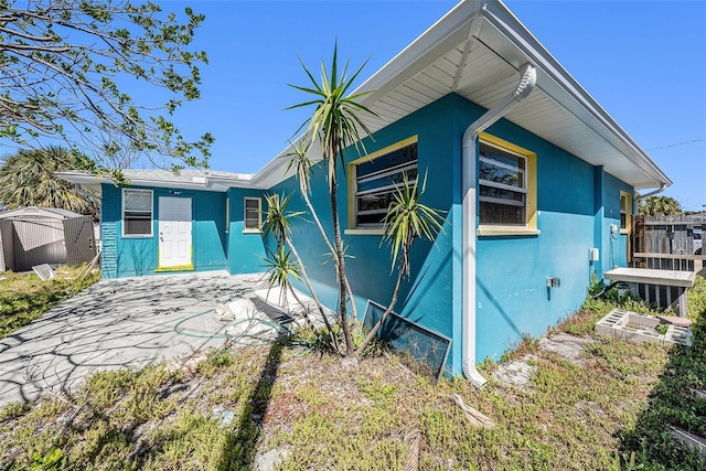 exterior space with fence and stucco siding