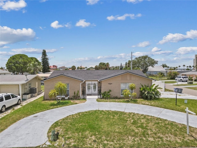 ranch-style home featuring a residential view, a front lawn, and a gate