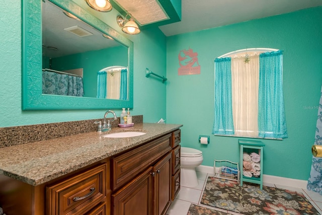 full bathroom with visible vents, toilet, tile patterned flooring, baseboards, and vanity