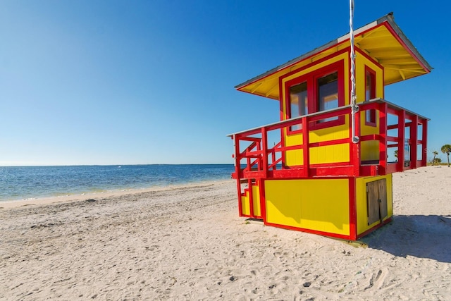 exterior space featuring a beach view and a water view