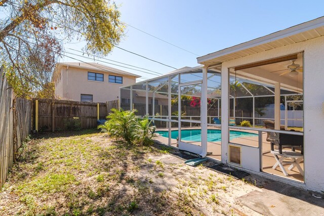 view of pool featuring a fenced in pool, a patio, glass enclosure, and a fenced backyard