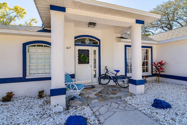 view of exterior entry with stucco siding