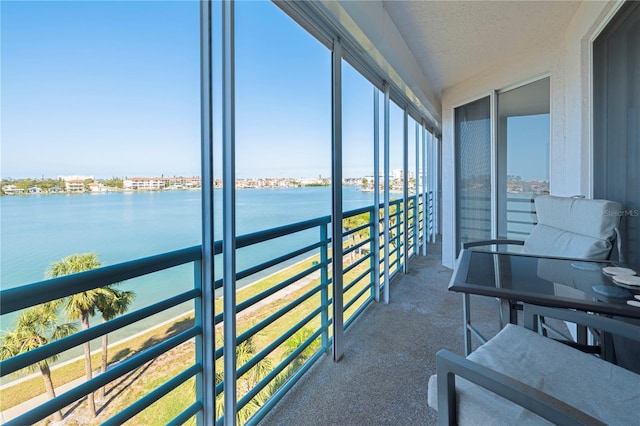 sunroom / solarium with a water view