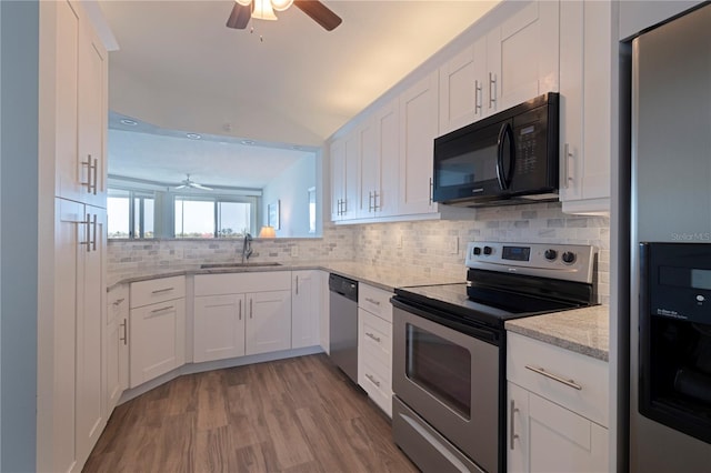 kitchen with a ceiling fan, a sink, decorative backsplash, appliances with stainless steel finishes, and white cabinetry